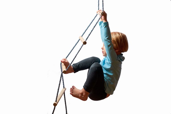 Young child climbing a rope ladder